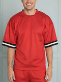 Red sports outfit with black and white trim on a white background