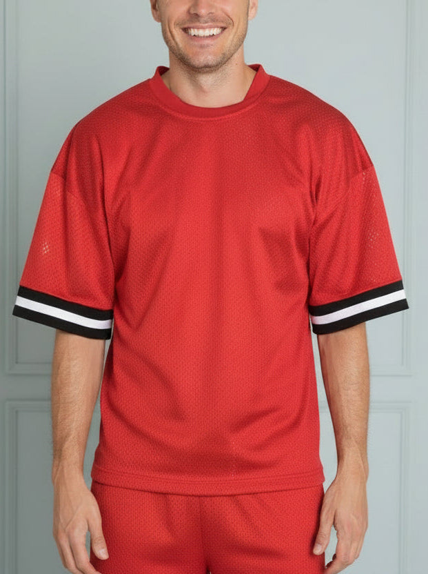 Red sports outfit with black and white trim on a white background