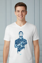 A man wearing a white V-neck t-shirt with a blue graphic print of a football player and the text 'LIFEWORTH NOTHING' on the front, paired with black pants against a light gray background.